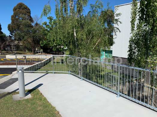 Interclamp pedestrian barriers and tube clamp fittings used to build a durable safety balustrade at a primary school, ensuring secure passage for young students.